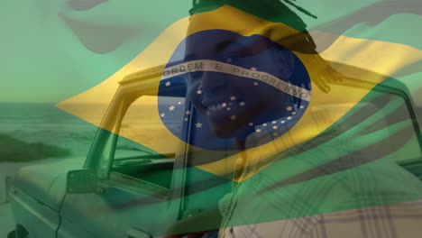 animation of brazilian flag waving over portrait of african american man standing by pick-up truck