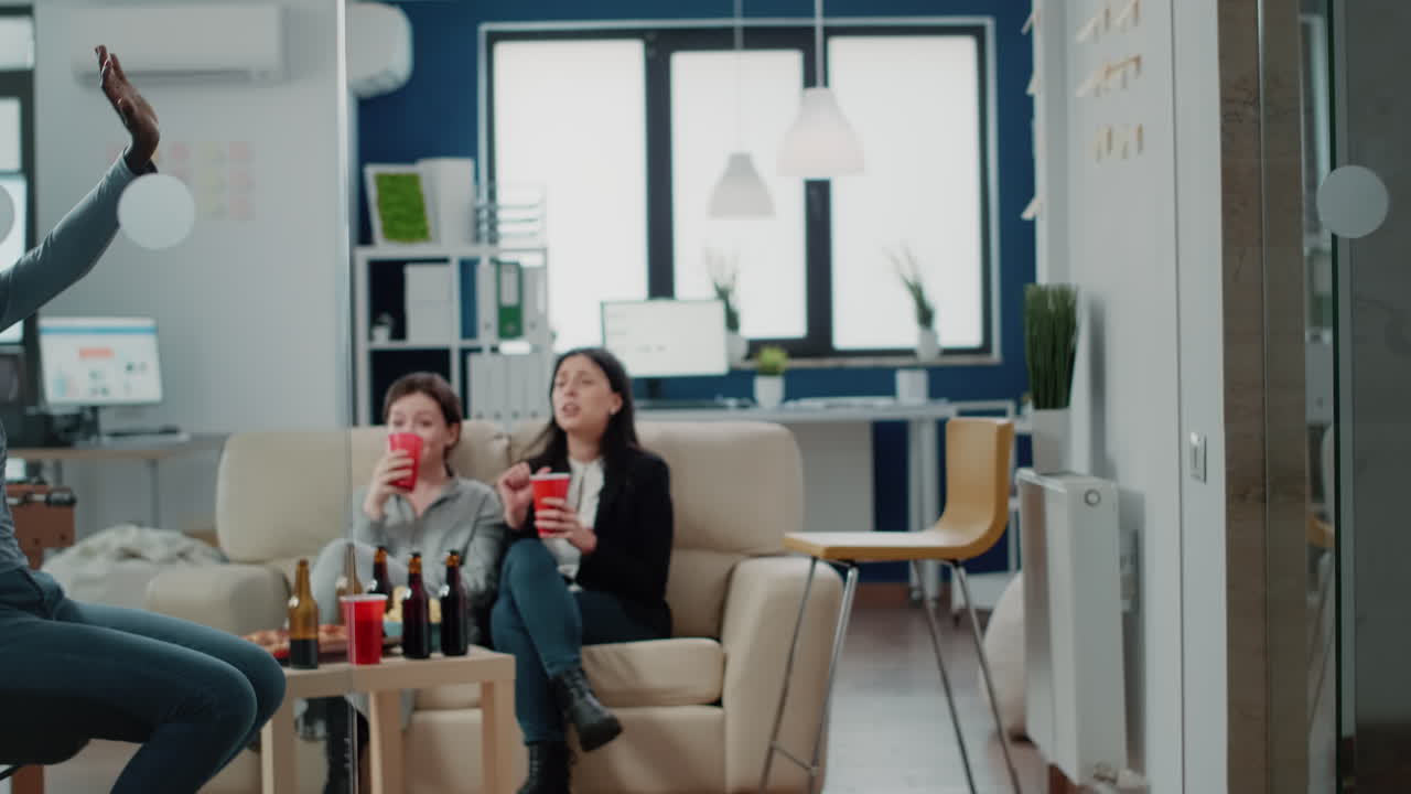 Man and african american woman having fun at office after work