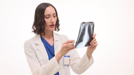 female doctor examining an x-ray film