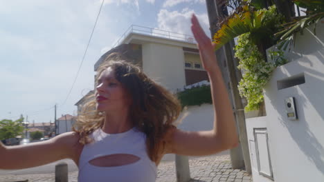 young woman dancing in city street