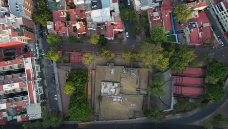 aerial drone shot of aztec original pyramid in the middle of mexico city and near main avenues