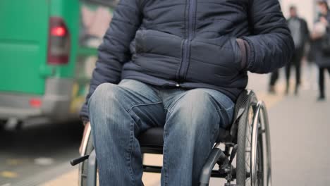 person with a physical disability waiting for city transport with an accessible ramp