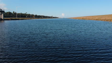 skimming low across a long canal