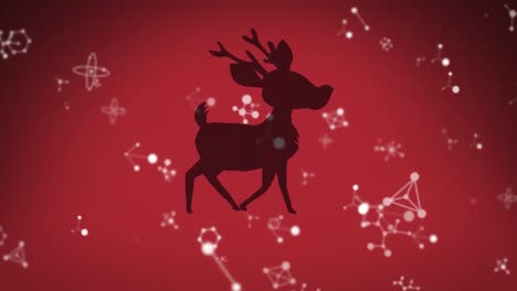 Molecular-structures-floating-over-black-silhouette-of-reindeer-walking-against-red-background