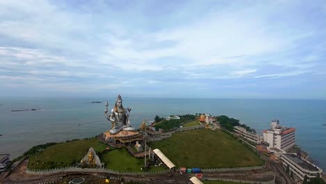 god statue aerial shots with arabian sea in the background at early morning