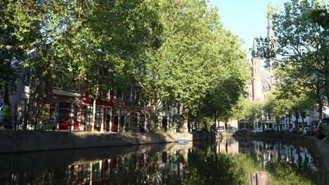 quiet street with typical waterfront buildings at hoge gouwe in gouda, the netherlands