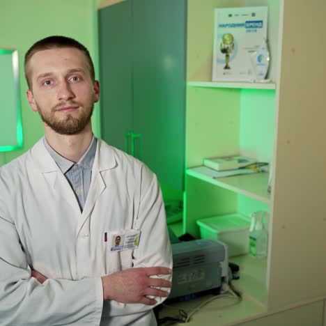 doctor posing at camera. cheerful young doctor posing and smiling at camera