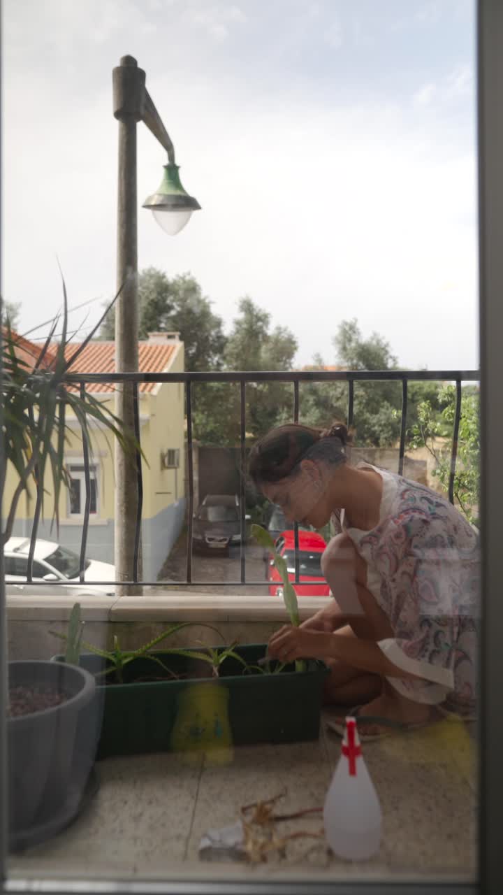 Woman gardening on a balcony