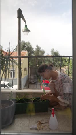 woman gardening on a balcony