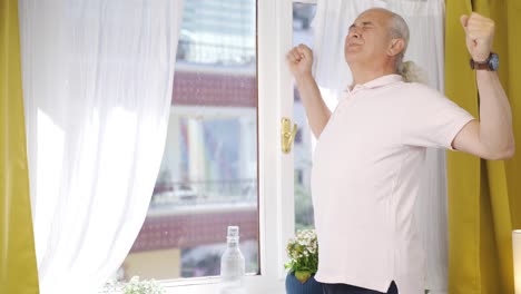 The-old-man-who-opens-the-curtains-yawns-and-relaxes.