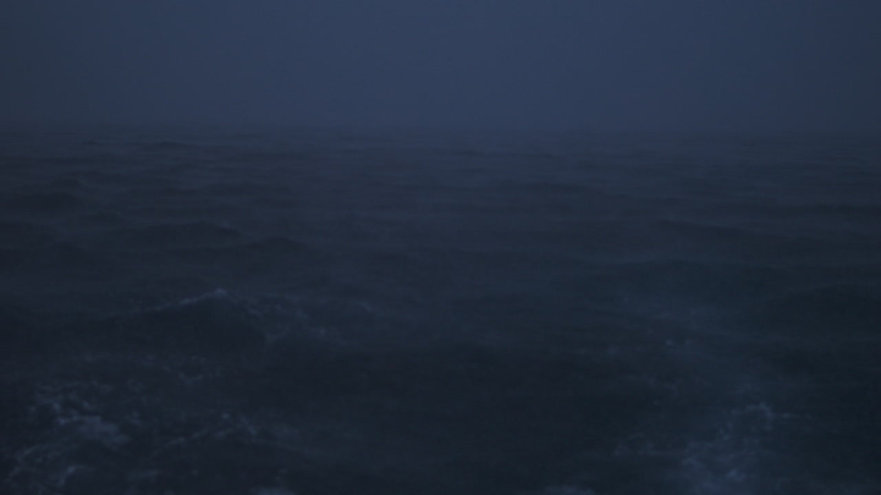 Stormy sea texture with heavy rainfall softening the horizon in slow motion