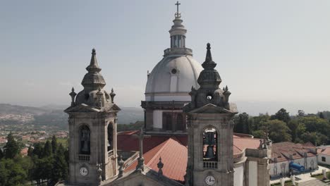 close up pan shot capturing the clock bell towers and dome monumental sanctuary of sameiro