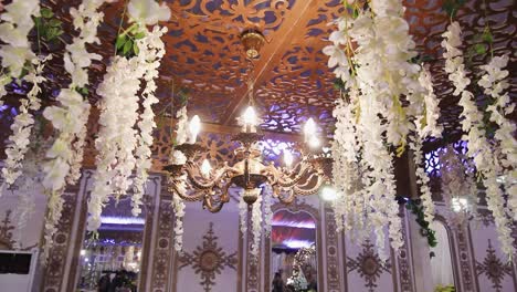 a stunning artificial ceiling adorned with elegant chandeliers featuring multiple white bulbs emitting a warm glow