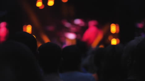 Bright-stage-lights-in-the-dark-and-audience-enjoying-the-concert