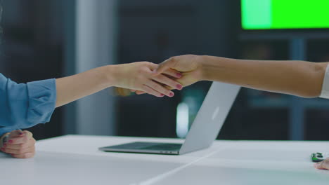 businesspeople shaking hands at a meeting