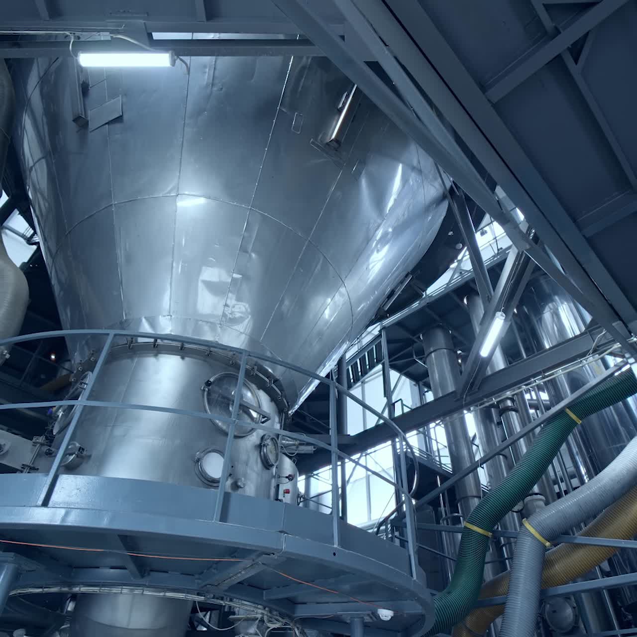 Big steel construction of milk factory. Modern food pipelines technology