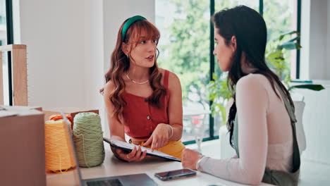 two women in discussion at a meeting