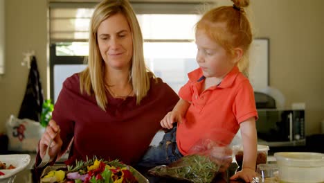 Mother-and-son-preparing-salad-in-kitchen-4k