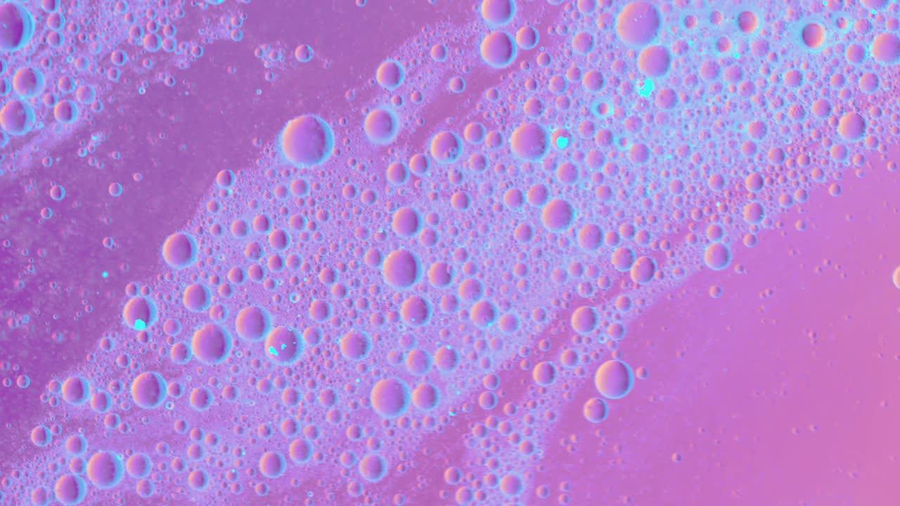 Pink Greasy liquid flows over a surface with bubbles and dirt