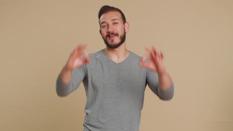 Man looking approvingly showing ok approve feedback gesture like sign positive something good