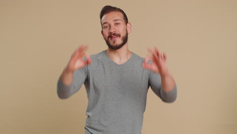 a smiling man with beard gives an okay sign with both hands.