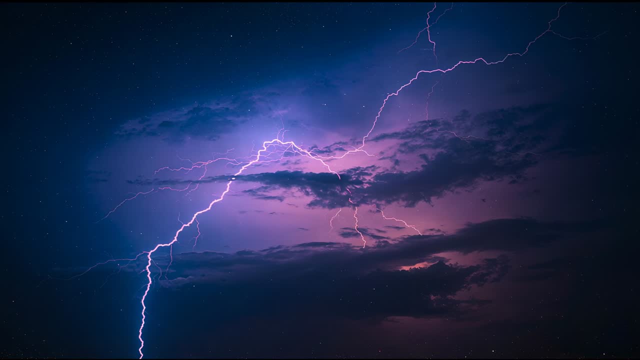 Flashing bright jagged lightning bolt releasing storm charge, lighting night clouds, then dimming