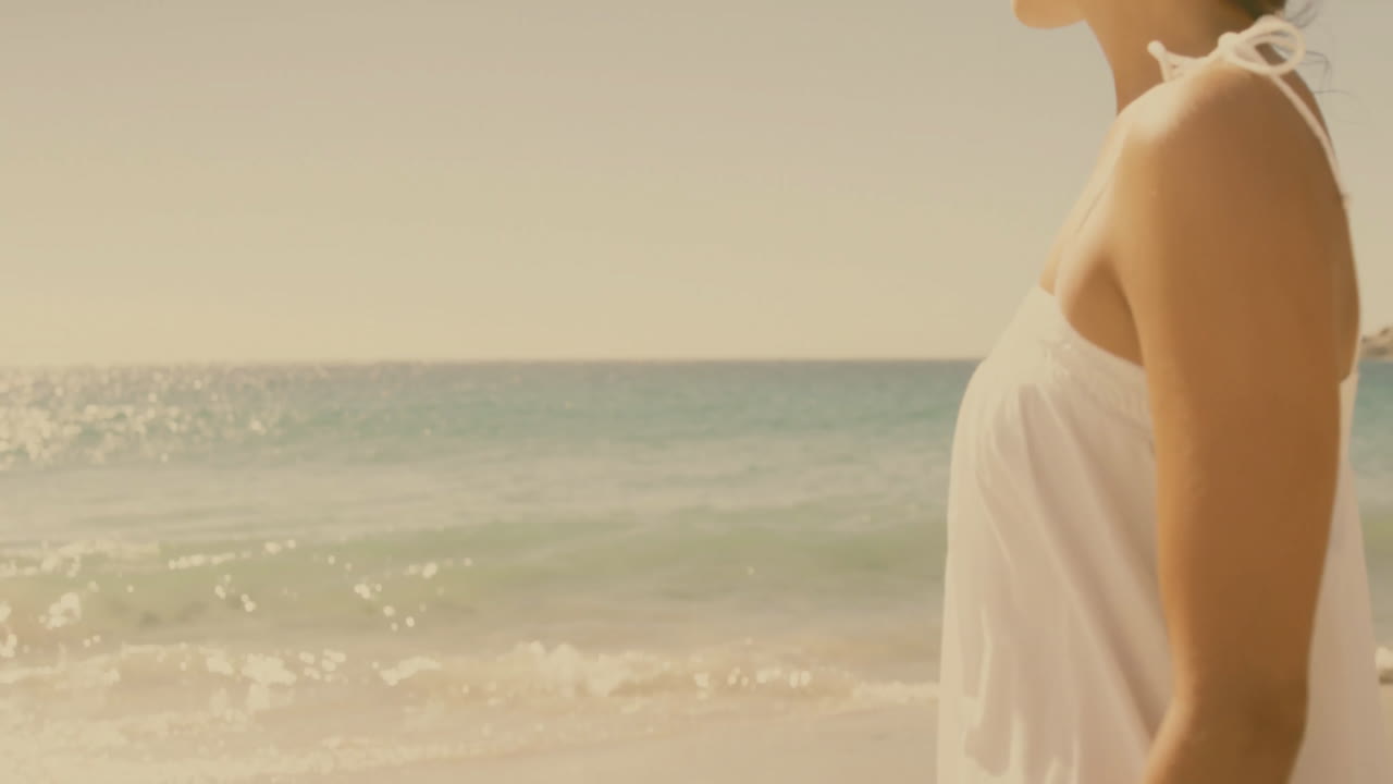 Gazing at horizon, person standing by ocean under clear sky with animation