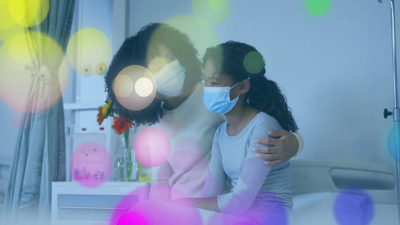 Masked woman comforting masked girl on hospital bed, showing floating heart icon and health graph