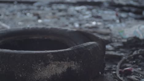 Old-black-tire-dumped-in-dirty-grunge-building