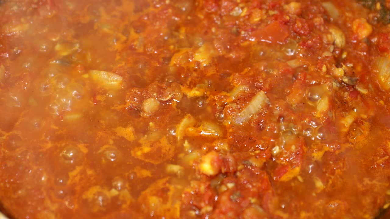 Detail shot of homemade boiling tomato sauce
