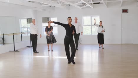 Profesor-De-Danza-Masculina-De-Raza-Mixta-Tomando-Una-Clase-De-Baile-De-Salón-En-Un-Estudio-De-Danza