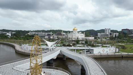 aerial-drone-shot-of-pedestrian-bridge-leading-towards-Sultan-Omar-Ali-Saifuddien-Mosque-in-Bandar-Seri-Bagawan-in-Brunei-Darussalam