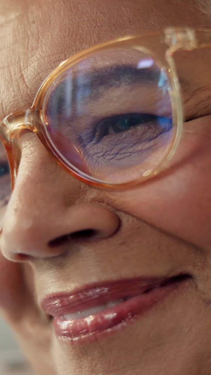 Close-up of Senior Woman's Eye with Reflection in Glasses