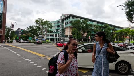 people and vehicles navigating an urban crosswalk.