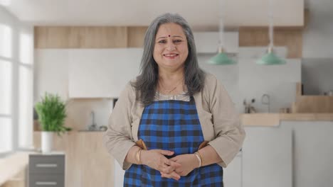 Happy-Indian-aged-housewife-smiling-to-the-camera