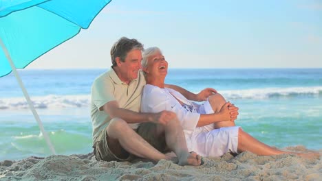 pareja madura abrazándose en una playa