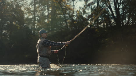 man fly fishing in a river