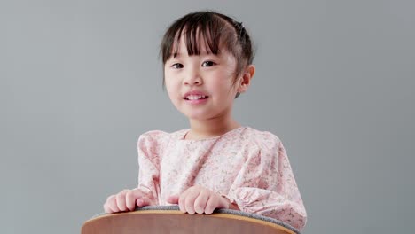 child with hand on head looking at camera