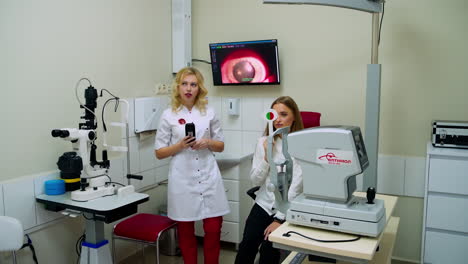 patient under eye vision examination. eye specialist in ophthalmologic clinic examines patient