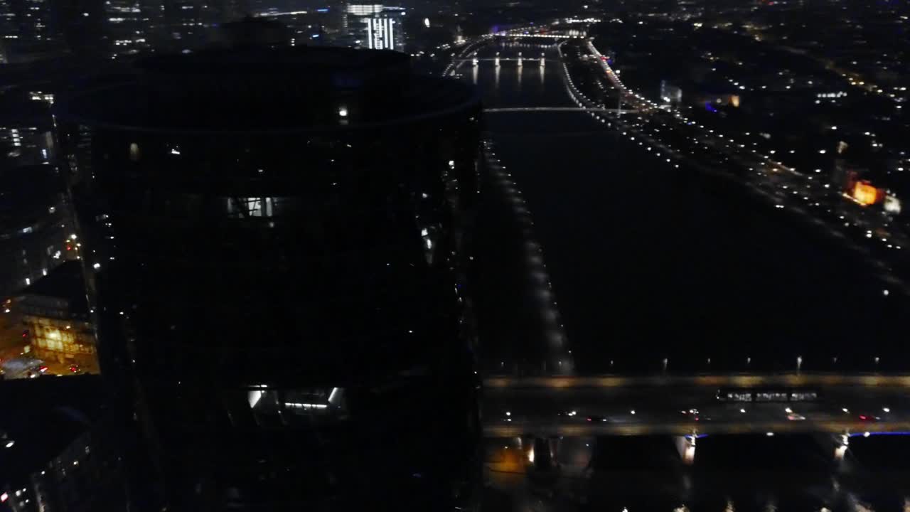 flying around a tower with the river main of frankfurt in the background at night