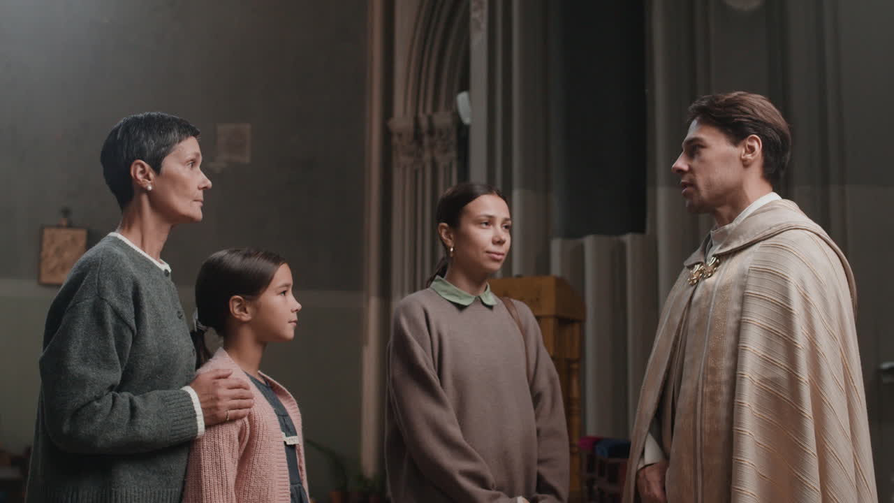 Family meets with priest in church