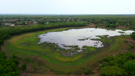 Aerial-Shot-of-water-filled-lake-surrounded-by-natural-bushland-in-rural-Australia