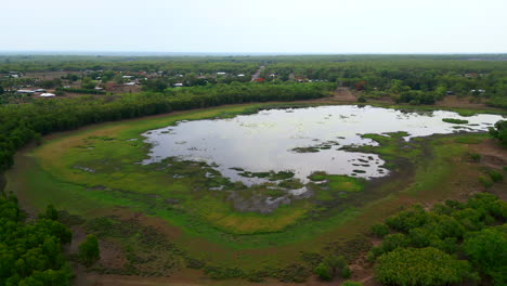 aerial shot of water filled lake surrounded by natural bushland in rural australia