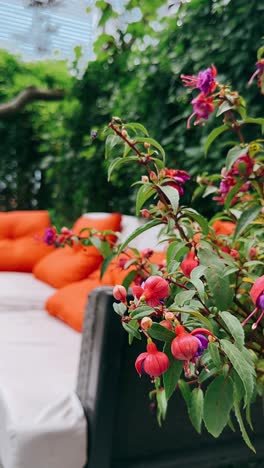 outdoor patio with fuchsia flowers and orange pillows