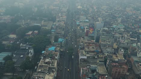 aerial drone shot offering a panoramic view of old delhi’s chandni chowk, where history meets modern-day hustle with packed streets and historic buildings.