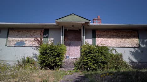 an abandoned and creepy house in canada during summer.
close shot.