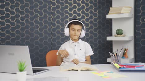 Boy-listening-to-music-with-headphones-at-home