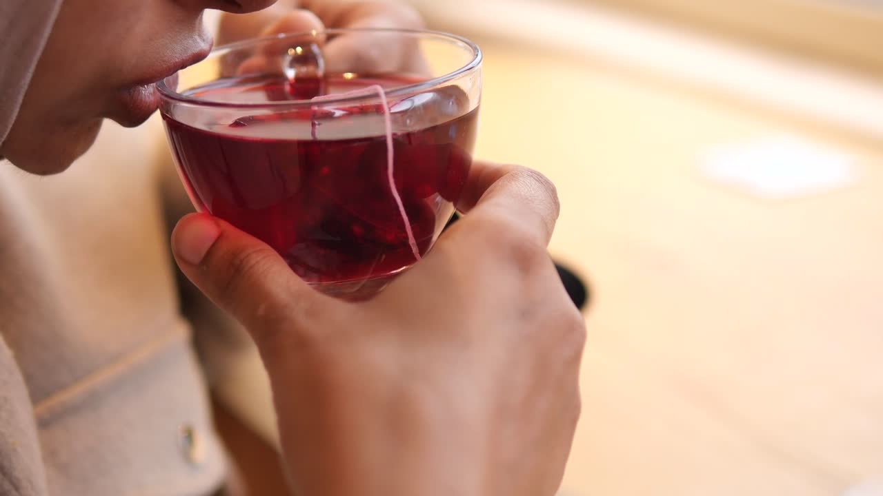 Person drinking hibiscus tea