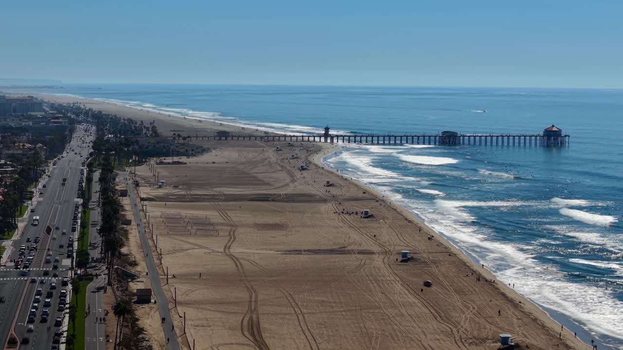 Timelapse Coastal view of Huntington Beach Pier, Pacific Coast Highway 1 Traffic, Orange County California, wide aerial Landscape looking south toward Newport and Laguna. Pacific West Coast
