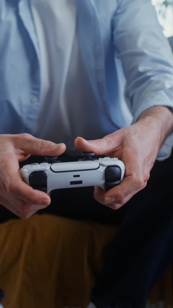Man holding a Playstation game controller